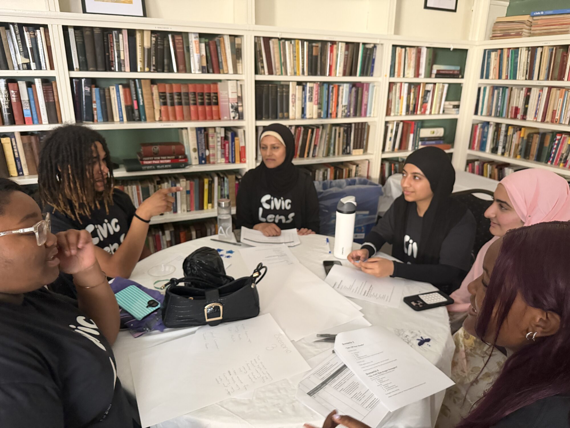 Participants seated around the table during a group discussion